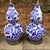 A beautiful pair of vintage double-gourd porcelain lamps featuring hand-painted cobalt blue floral and geometric motifs in...