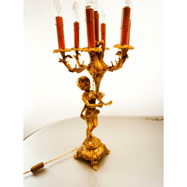 Bronze Putto Lamp with Six Lights, in Very Good conditions. Designed 1920 to 1949 European Plug (up to 250V).The wiring of...