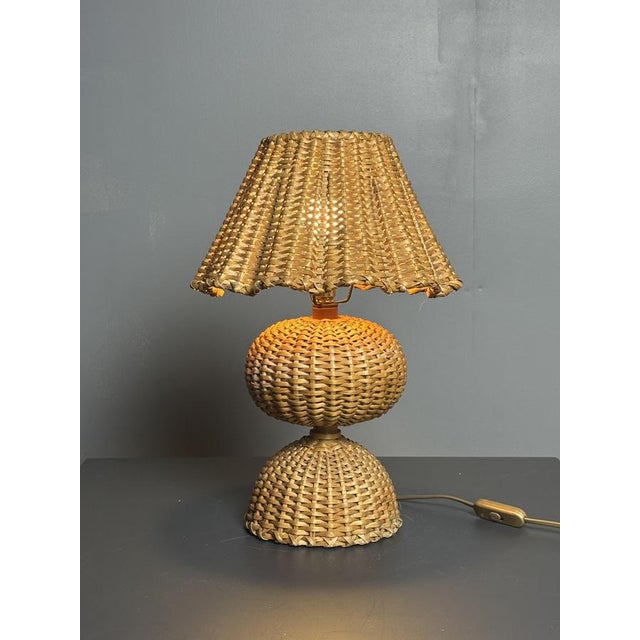 One of the loveliest wicker lamps we've encountered in along time. French, midcentury and in great vintage condition with...