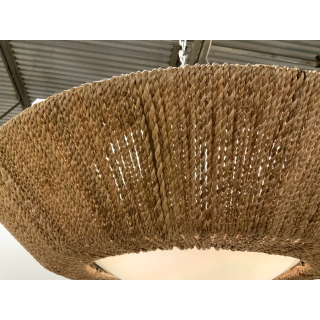 Stylish Currey & Co. Organic Modern Jute Saucer Chandelier, frosted top and bottom, showroom floor sample