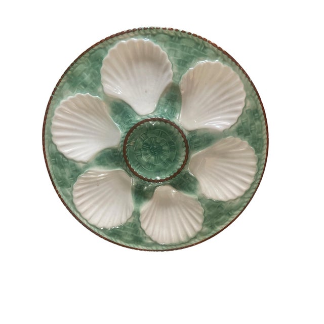A striking set of four 1950’s French Faience Longchamp glazed majolica oyster plate with a vibrant green basket weave...