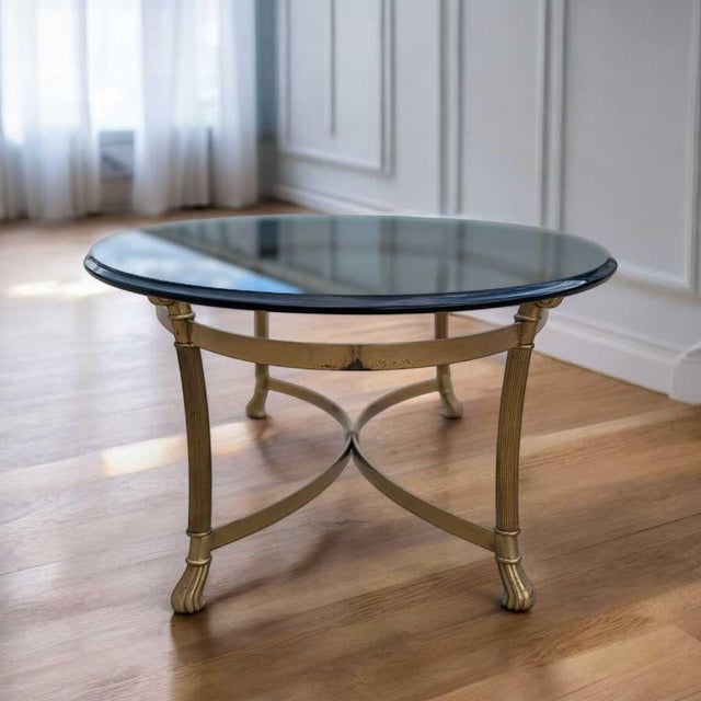 LaBarge Glass Top Brass Coffee Table. A vintage LaBarge coffee table with an oval glass top and brass-toned metal base....
