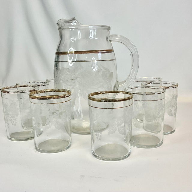 Offering a Pitcher and glassware juice set from the 1950s. It’s transparent clear glass with gold bands. Additionally...