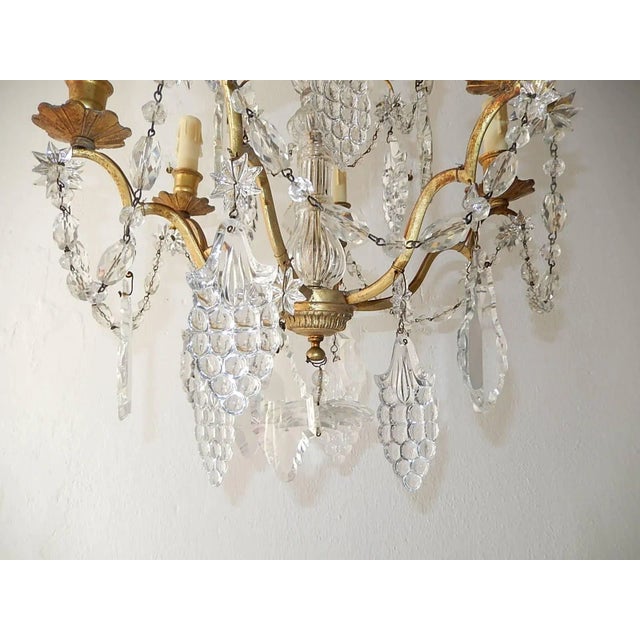 Housing six lights, star prisms throughout with crystal prisms and rare grape cluster prisms. Blown glass centre. Huge...