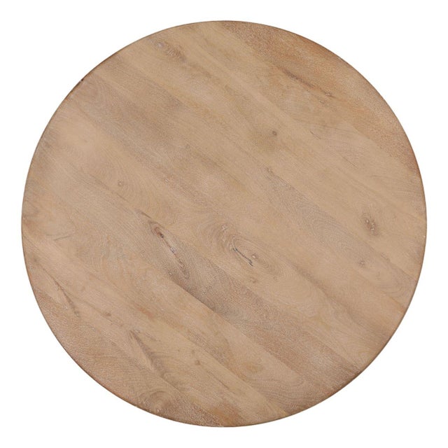 Round solid natural wood coffee table with a sculptural pedestal base and warm organic finish. The clean circular top and...