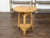 An English rustic pine cricket table from the 19th century, with circular top and triangular shelf. Created in England...