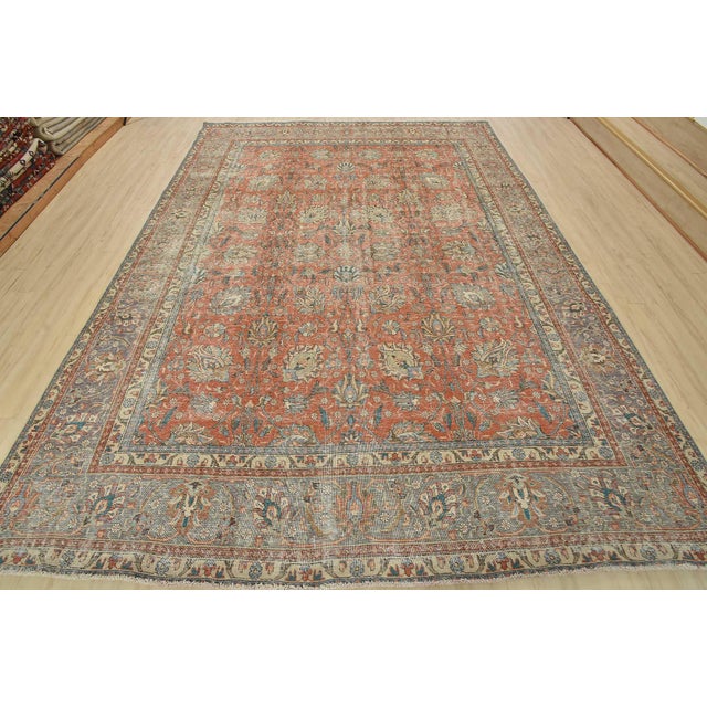 An authentic vintage traditional Tabriz rug hand-knotted with fine wool and natural dyes. This oriental rug features an...