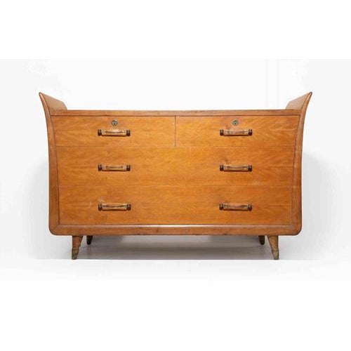 A refined and sculptural mid-century Italian chest of drawers, attributed to Vittorio Dassi, embodying the sophisticated...