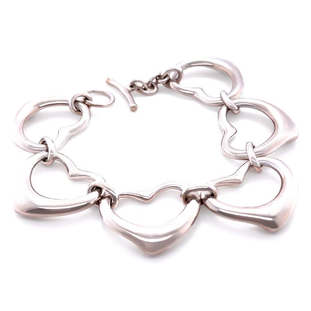 A rare vintage Tiffany & Co. Elsa Peretti Six Heart bracelet crafted in sterling silver, featuring the designer’s iconic...