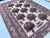 This charming rug features the classical vase design: a grid of stylized urns brimming with flowering bouquets in navy,...