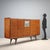 Italian-made sideboard dating back to the 1950s and 1960s, crafted from wood with a mahogany veneer. Featuring hinged...