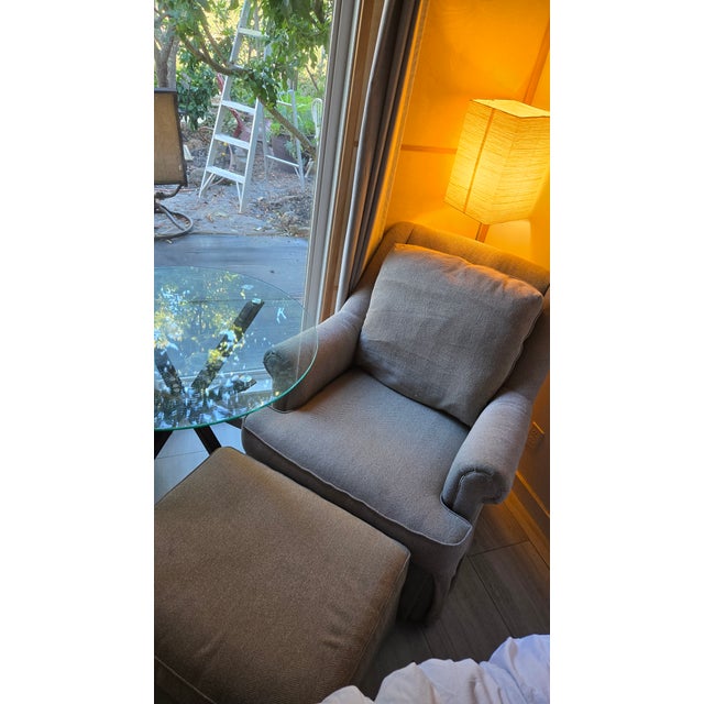 Presenting an exceptional, bench-made stationary lounge chair and matching ottoman from the prestigious "Tyler" Custom...
