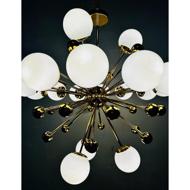 Iconic Sputnik chandelier from the 1970s, made in Italy. The central polished brass structure branches into 18 arms that...