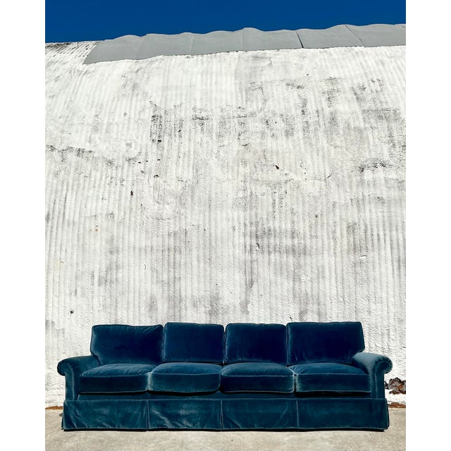 Immerse your space in rich color and indulgent comfort with this vintage Regency-style cerulean velvet sofa, inspired by...