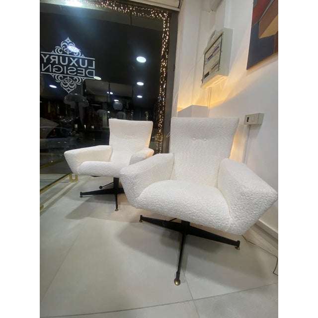 Pair of 1960s swivel armchairs. Black metal frame with brass feet, wide, comfortable seat, and stain-resistant, water-...