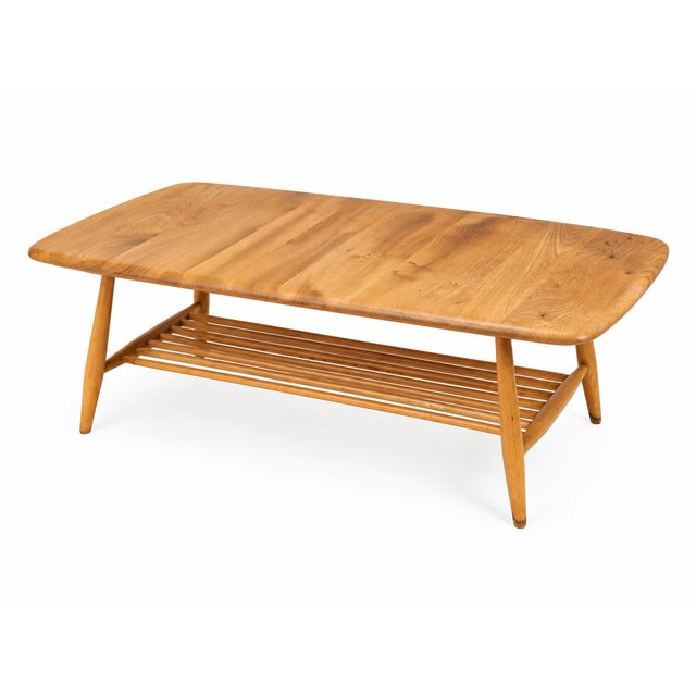 A beautifully restored Ercol Windsor plank coffee table, featuring the classic rectangular rounded-edge top, tapered legs...