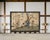 A dramatic six-panel decorative Chinese Export Coromandel screen featuring a warm, luminous reflective gold-leaf ground...