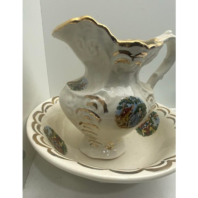 Beautiful vintage Victorian-style ceramic pitcher and matching wash basin set featuring romantic courting couple scenes,...