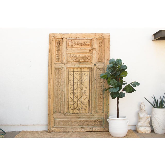 Sourced from a riad renovation, this large door carries the hand-carved geometric vocabulary of Atlas Mountains Berber...