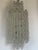 Large chandelier with cascading pendants in the shape of a spinning top, designed and produced by the Murano company...