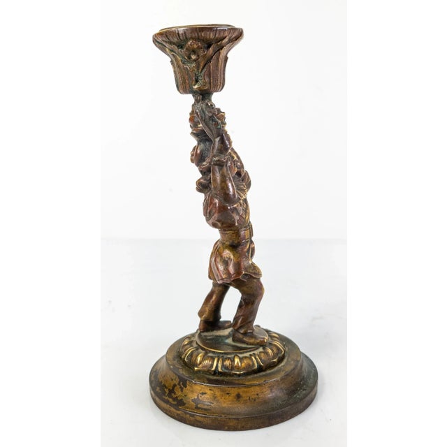 We are selling this antique bronze Candlestick. I believe the candlestick is meant to represent an early American Colonial...