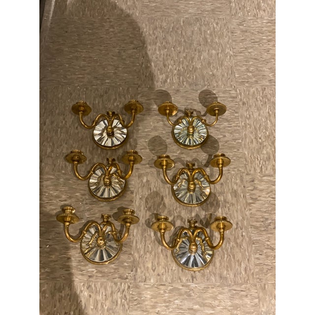 A pair of circa 1920’s Caldwell small gilt bronze sconces with beveled mirror backplate