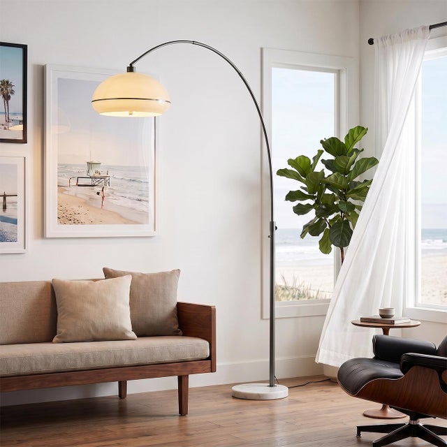 A sweeping arc of black nickel and white marble, engineered to light a room like a chandelier - without touching the...