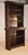 19th century oak tall carved bookcase from England. At the top, there is a stately crown molding with carving as well for...
