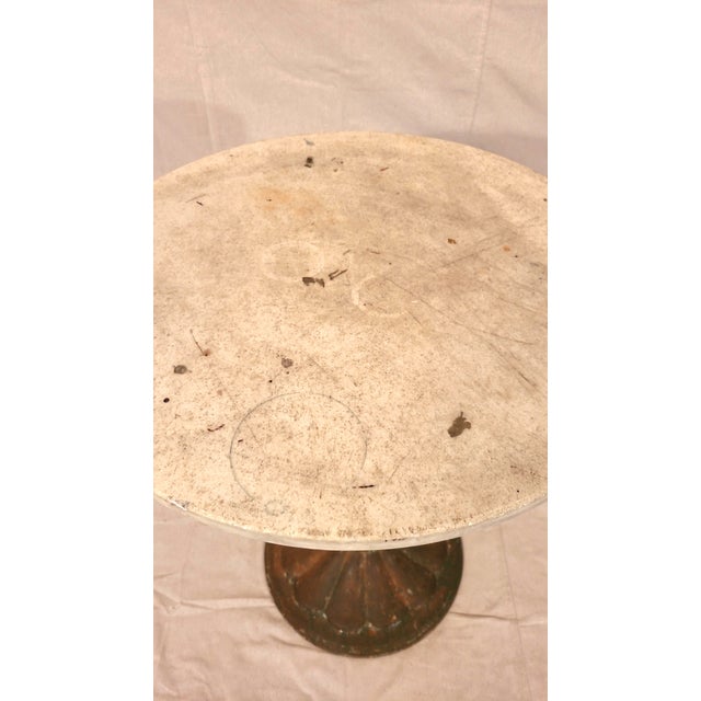 This is an antique French bistro table with a cast iron base and loose stone top straight from the streets of Paris. c....