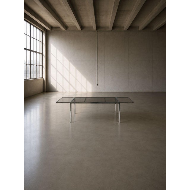 Milo Baughman Style, American Mid-Century Modern, Expanding Dining Table, Chrome, Smoked Glass, USA, 1970s An interesting...