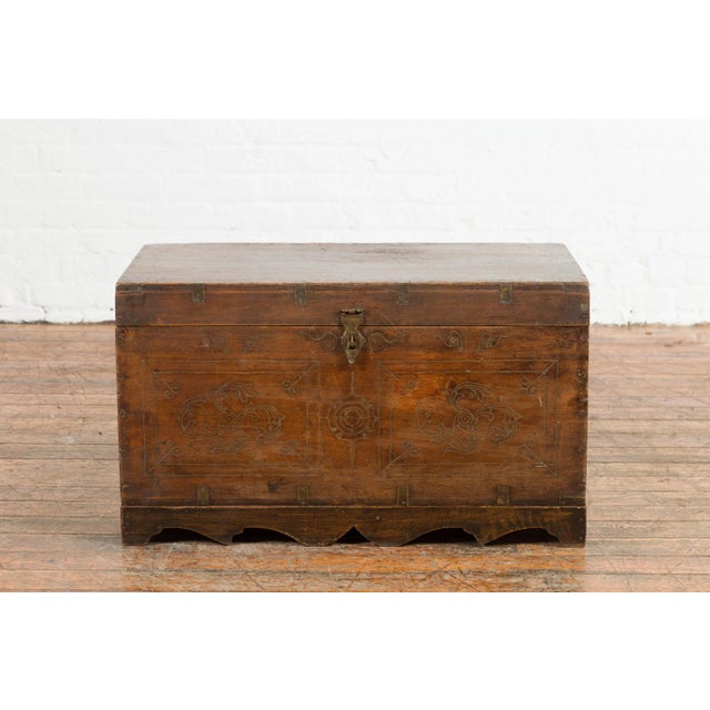 A Indian wedding chest from the mid 20th century, with brass accents, multiple jewelry compartments, floral décor and...