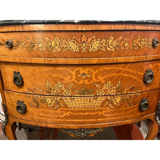 Marble top three drawer floral motif Commode A refined blend of classic form and decorative artistry, this three‑drawer...