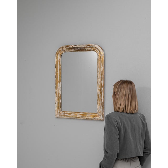 This 1880s French wood patinated mirror offers a refined balance of simplicity and historic charm, defined by its gently...