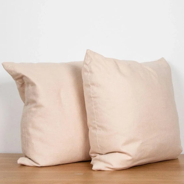 Square linen pillow with zipper closure.
