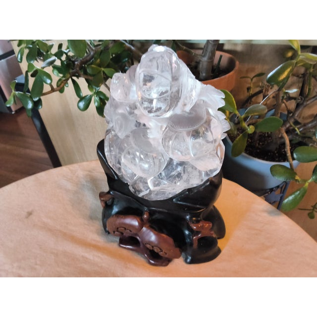 This old Chinese piece is assembled from 2 parts; a hand carved rosewood stand and a carved and etched crystal sculpture....