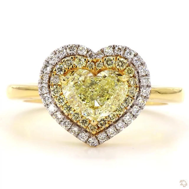This ring from our contemporary estate collection centers on a 1.02-carat yellow yellow diamond in a romantic heart shape....