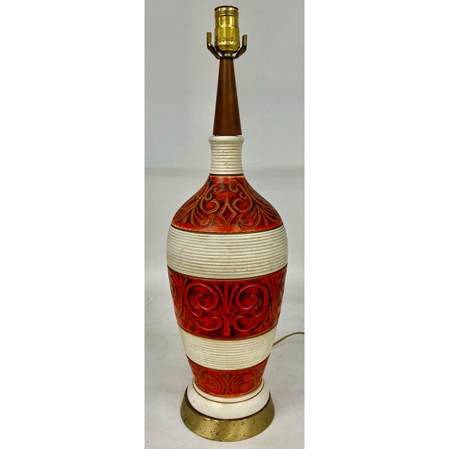 Fun Midcentury ceramic lamp in orange and off-white. Original foil label from Regal lamps.