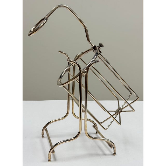 Lovely vintage silver-plated wine bottle holder featuring and adjustable neck ring to accommodate different bottle shapes....