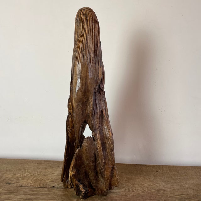 Naïve sculpture of a bearded man carved from hand-carved root wood, folk art. What distinguishes folk art is its deep...