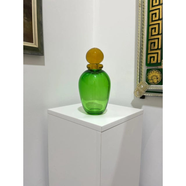 Very pretty vintage vase from Murano, Italy. Beautiful colors of green and amber. A nice accent piece. Measures 11" tall....