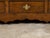 An English Georgian period small oak buffet from the 18th century, with double doors, drawers, arching motifs and brass...