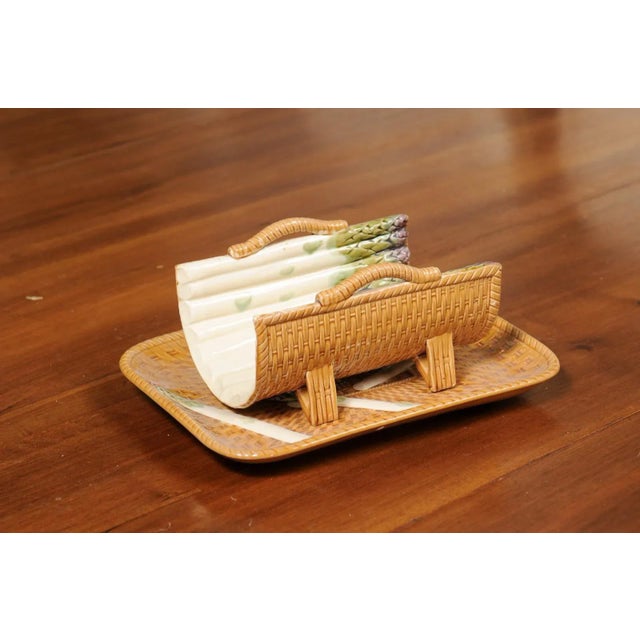 A French Majolica asparagus tray from the 19th century, with large cradle and wicker motifs. Created in France during the...