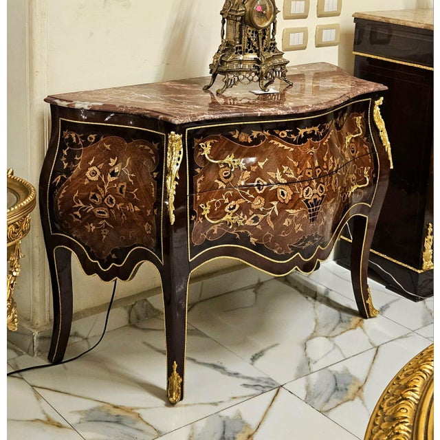 Make a statement with this magnificent French bombe commode, showcasing exceptional floral marquetry, graceful serpentine...
