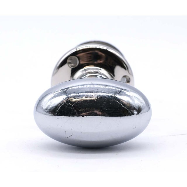 Vintage oval polished nickel plated brass doorknob with a matching closet turn latch. The set includes one large rosette...