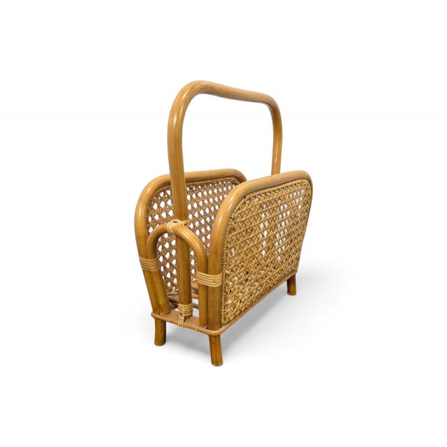 Elegant and functional, this mid-century vintage magazine rack is handcrafted from honey-toned wicker and bamboo. The...