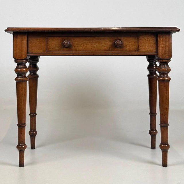 A beautifully crafted 19th-century English Victorian side table, finely constructed in mahogany and combining elegant...