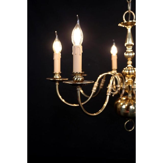Renovated Dutch chandelier in gold color made of polished brass. Eight-arm design. The chandelier has a completely new...