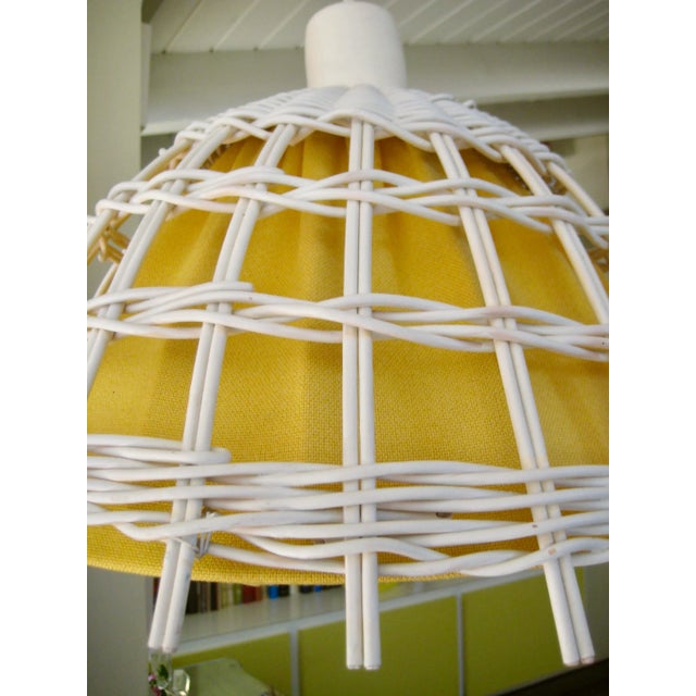 This chandelier is from 1960 in white wicker with a yellow textile insert, and a porcelain top, you will see a picture...