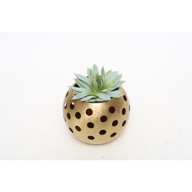 Brass ball candle holder. Brass tea light with perforated holes, makes an elegant effect when lit with a tea light candle....