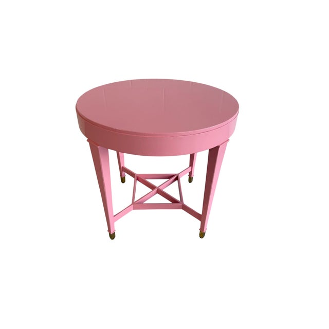 A classic Baker Milling Road accent table featuring a clean round top, tapered legs, and a geometric stretcher base...